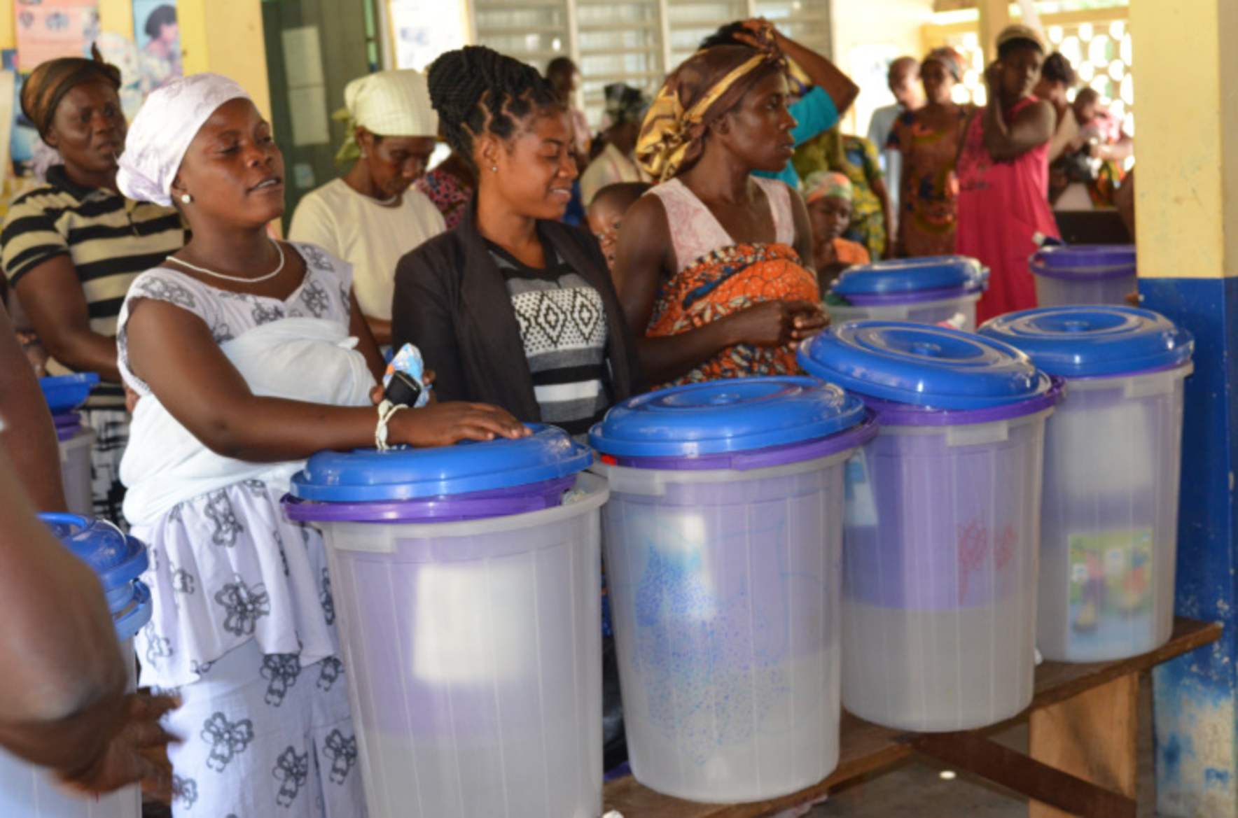 Ghanaian women show off their new water filters.